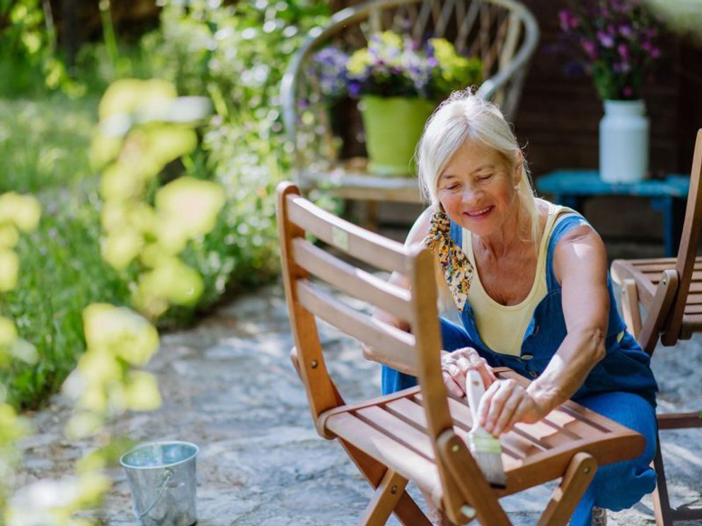 Lady oiling teak furniture
